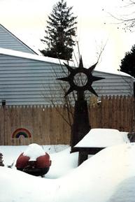Melded steel sculpture by Dave Fontana, outside his mothers house after a snow storm